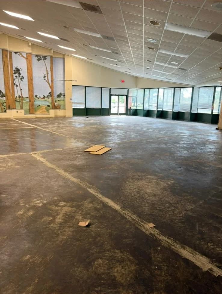 Old flooring stripped down to bare, prepped subfloor on a commercial job