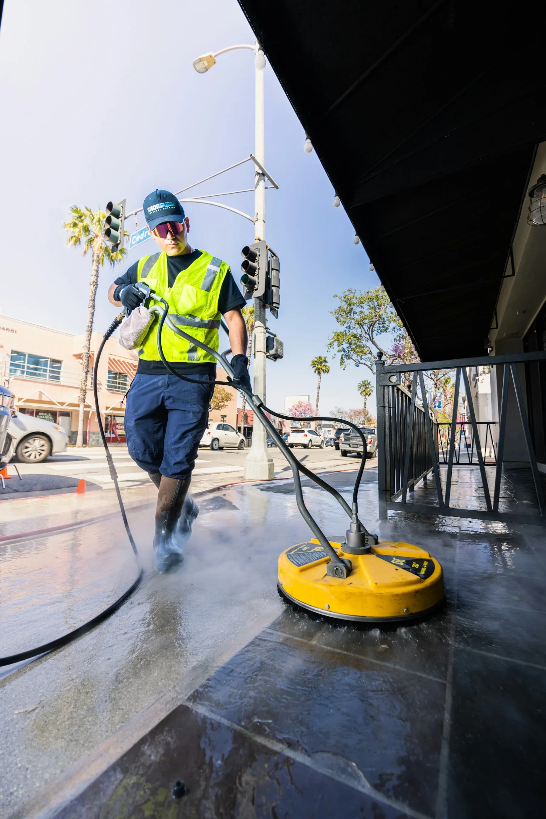Commercial building exterior concrete apron half pressure-washed