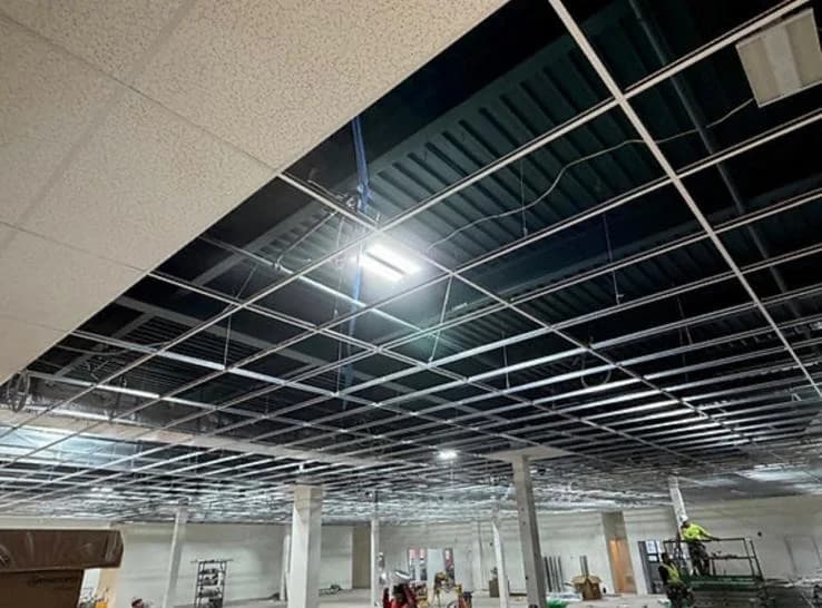 Suspended ceiling grid installed across a large commercial space, ready for tile