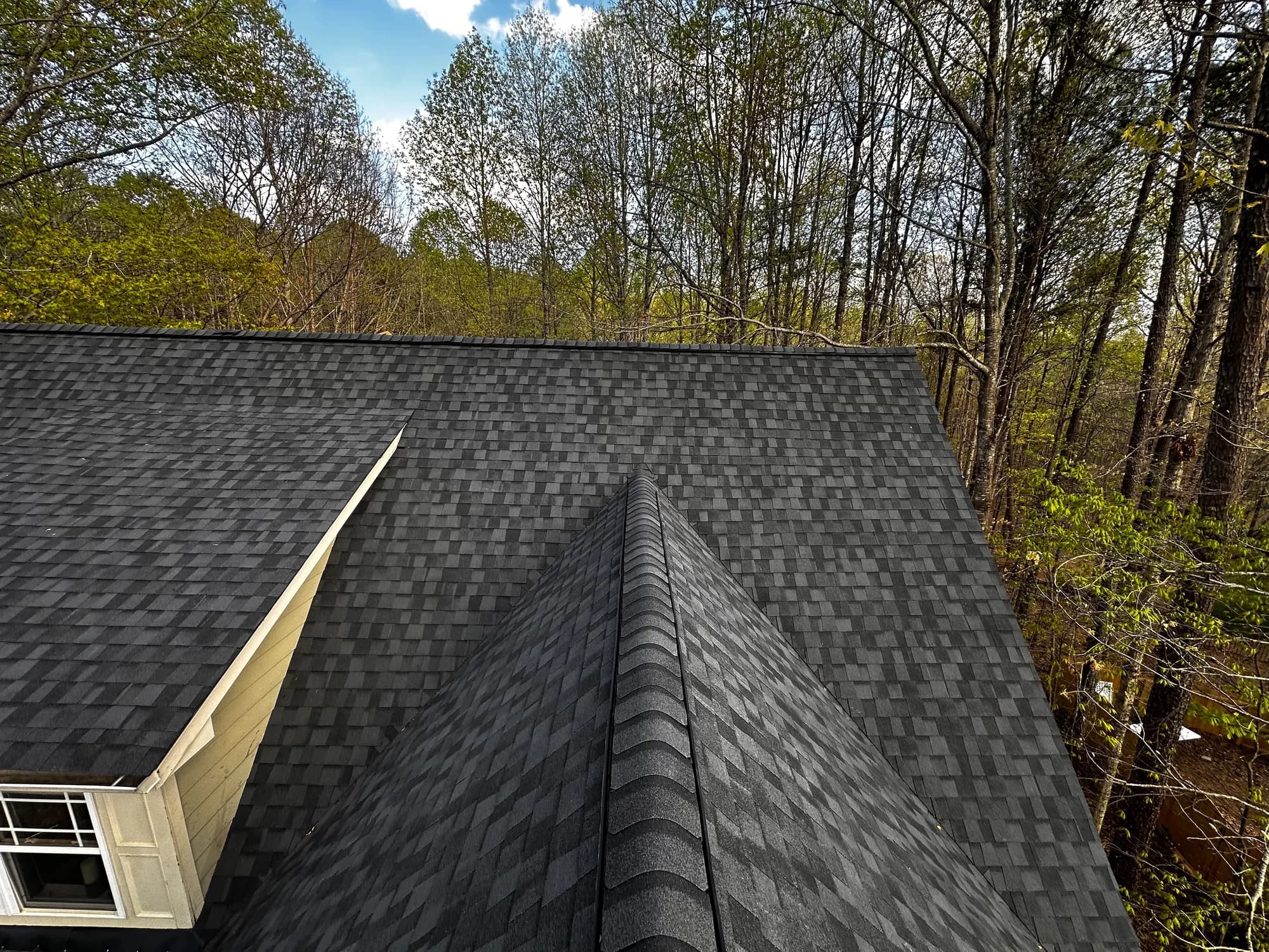 Finished residential roof with new shingles installed